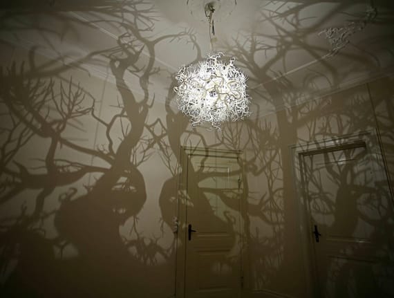 Chandelier Casts Tree Shadows On Wall