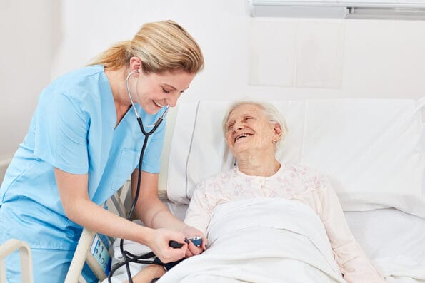 Nurse or nurse checks the blood pressure of a senior citizen