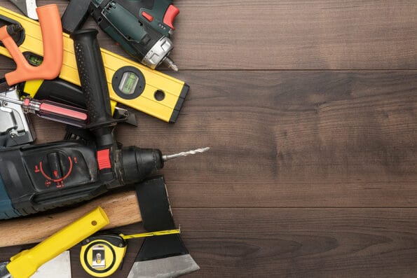 construction tools on wooden background. different tools with copy space. diy construction tools on the brown table. top view of most important building tools
