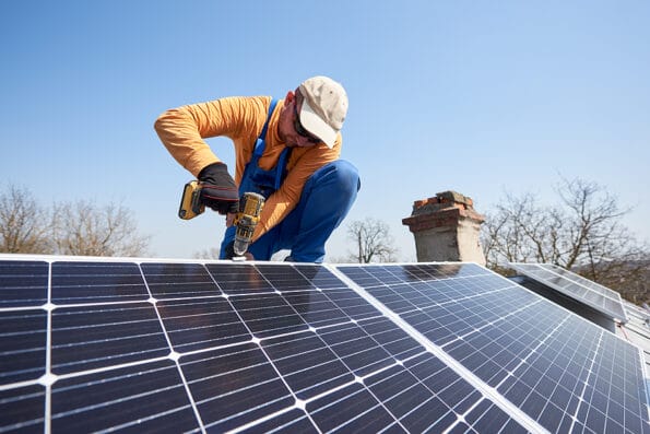 Male Engineer Installing Stand-alone Solar Photovoltaic Panel Sy