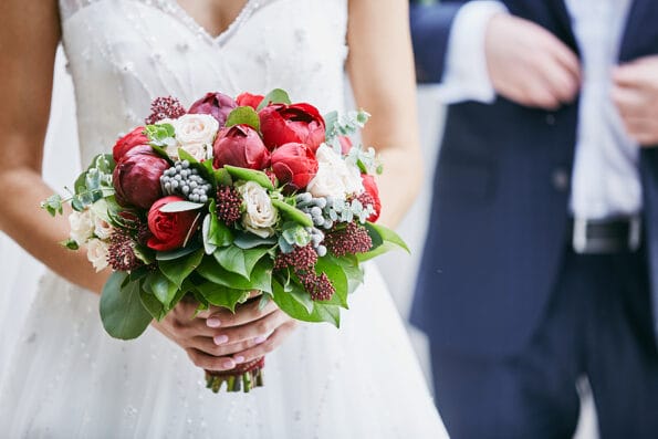 Bride holds a wedding bouquet, wedding dress, wedding details. Beautiful luxury wedding blog concept. Summer wedding.