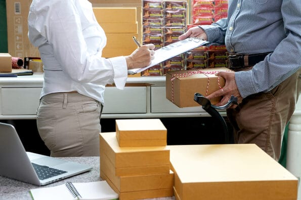 Small business woman Worker delivery service and working packing box, business owner working checking order to confirm before sending customer in post office, Shipment Online Sales with barcode scanner.
