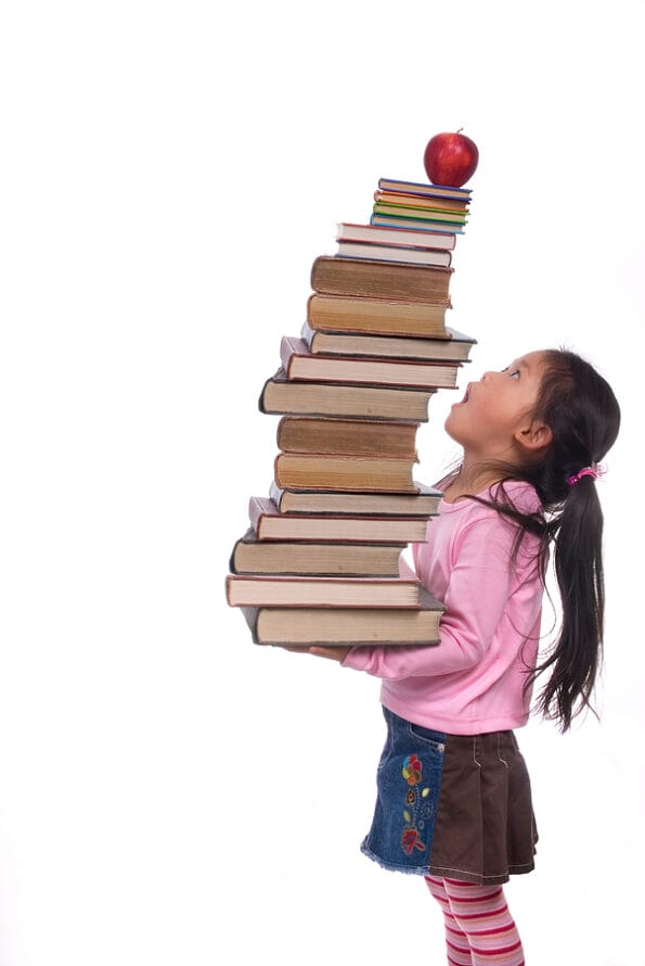 The power of the future is your education. A young girl hold a tall tower of books. The weight of education.