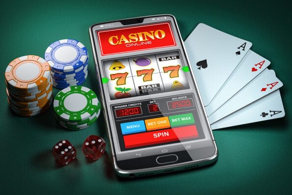 Online casino and gambling concept. Slot machine on smartphone screen, cards, dice and poker chips. 3d illustration