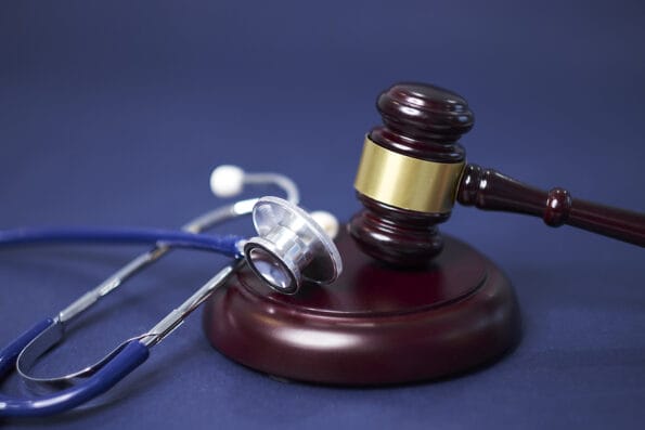 Stethoscope and judgement hammer. Gavel and stethoscope. medical jurisprudence. legal definition of medical malpractice. attorney. common errors doctors, nurses and hospitals make.