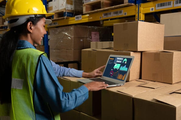Warehouse management software application in computer for real time monitoring of goods package delivery . PC screen showing smart inventory dashboard for storage and supply chain distribution .