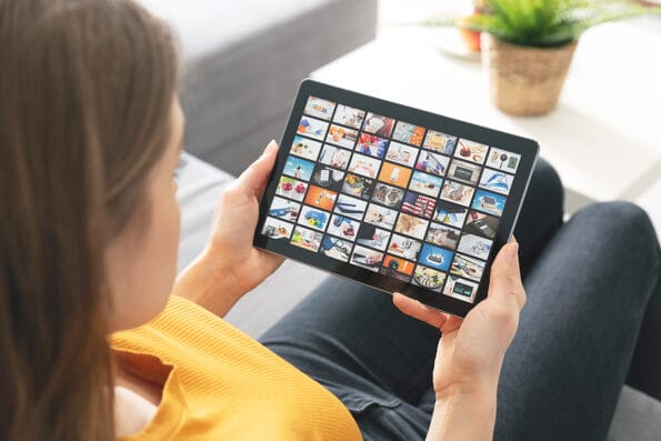 Woman watching TV on tablet. Television, multimedia streaming services