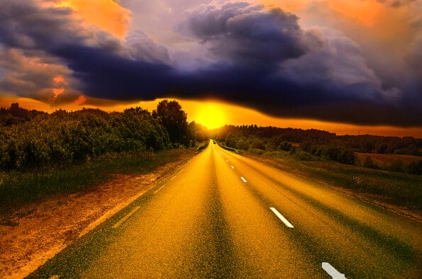 Beautiful sunny road in the morning. Beautiful sun rising sky with asphalt highways road and storm clouds, Driving on an empty road at lovely sunny day. Sun rising over asphalt country open road in sunny morning or evening. Open road at sunny sunset or su