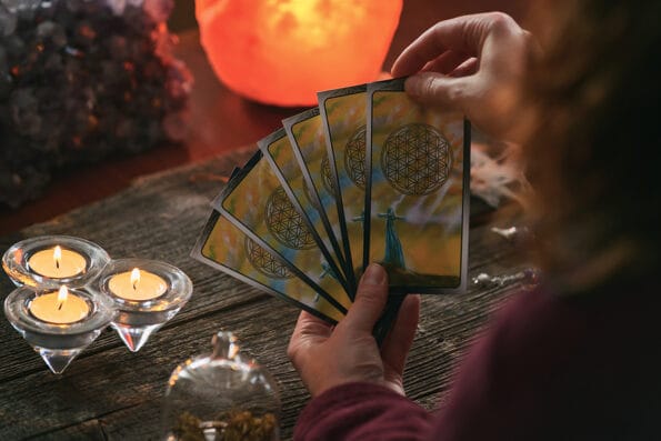 Woman holds tarot cards in her hands. Concept of psychic advisor or ways of divination