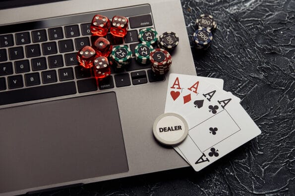 Chips, dices and playing cards with aces for poker online or casino gambling. Online casino concept
