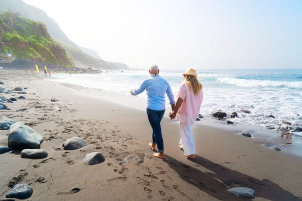 lifestyle with caucasian senior couple walking on beach, happy in love romantic and relax time, tourism of elderly family pleople, leisure and activity travel after retirement in vacations and summer