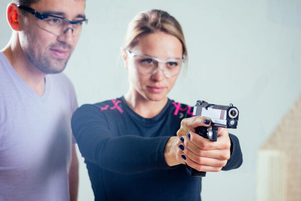 A person target practicing with a handgun for self defense