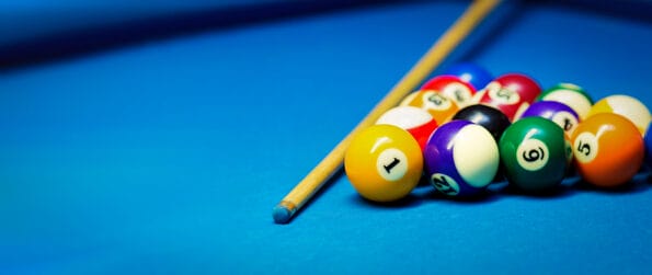 pool tables billiard pool balls rack and cue on the blue cloth table. banner copy space