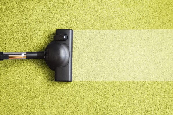 vacuum cleaner on the floor showing house cleaning concept
