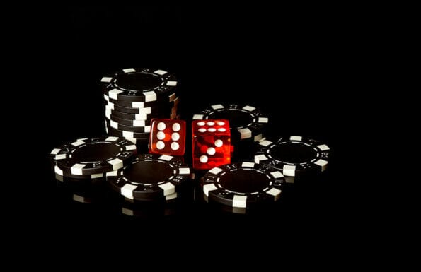 Black chips and red dice received as a result of winning. Craps is a dice game in which players bet on the outcomes of a pair of dice